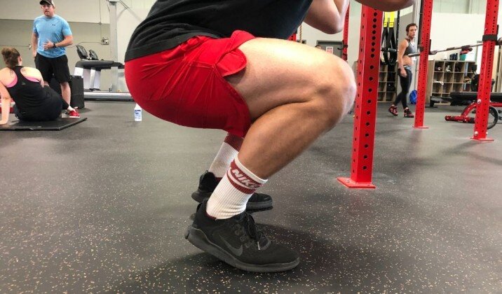 Not having your heels flat on the floor can cause wrist pain when front squatting