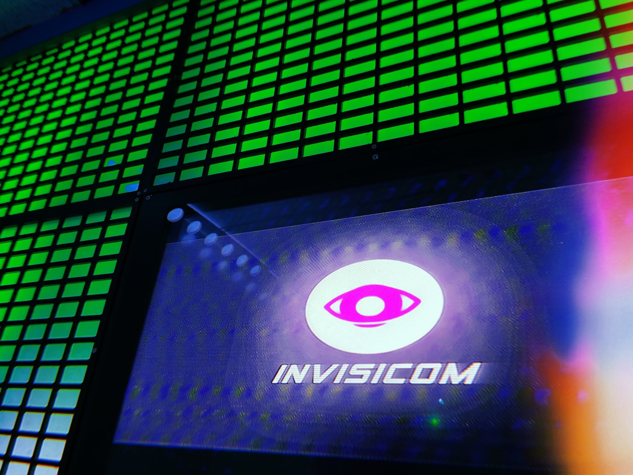  Invisicom displays on the screens. The computer glows green 