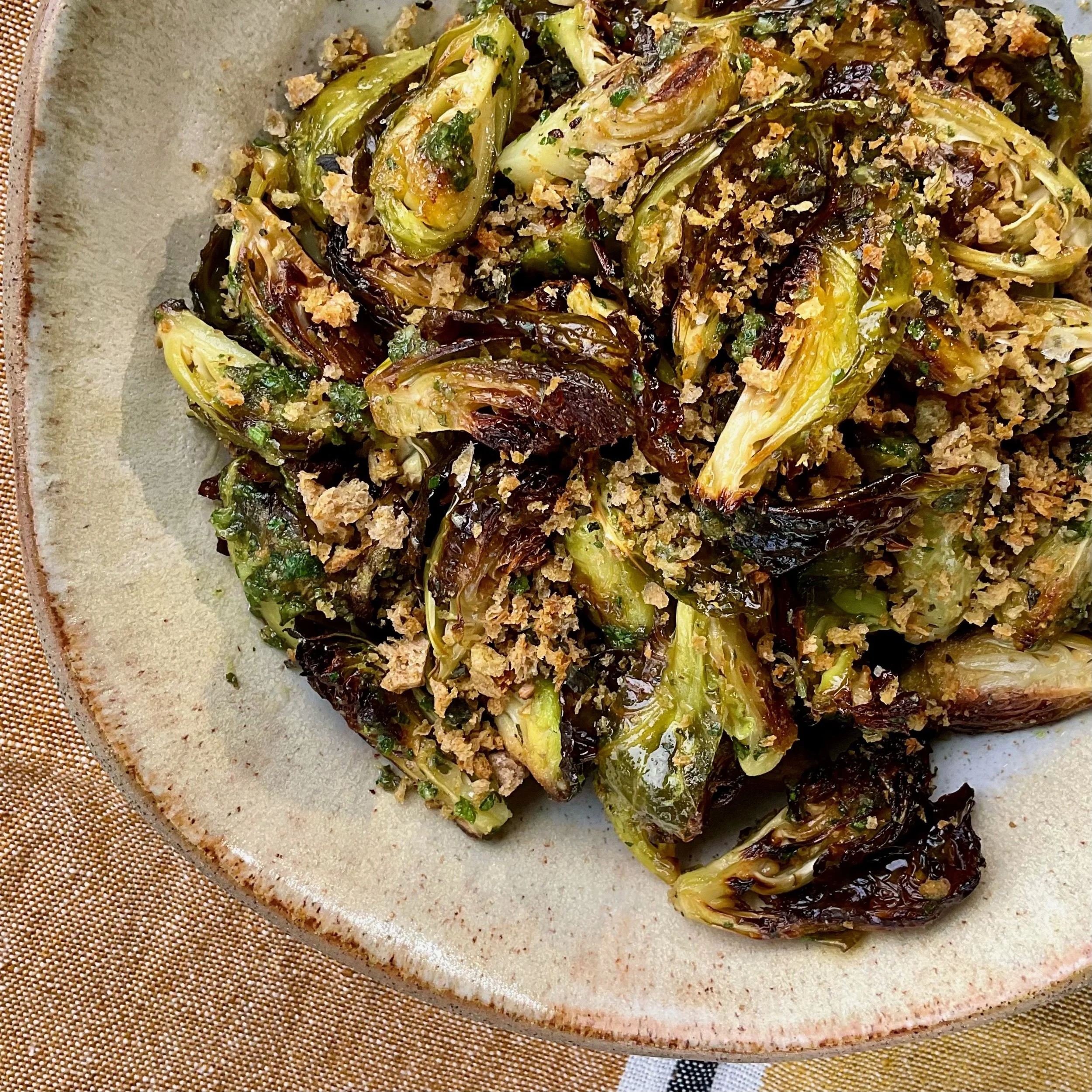 CRISPY ROASTED BRUSSELS SPROUTS TOSSED IN PESTO AND BREADCRUMBS