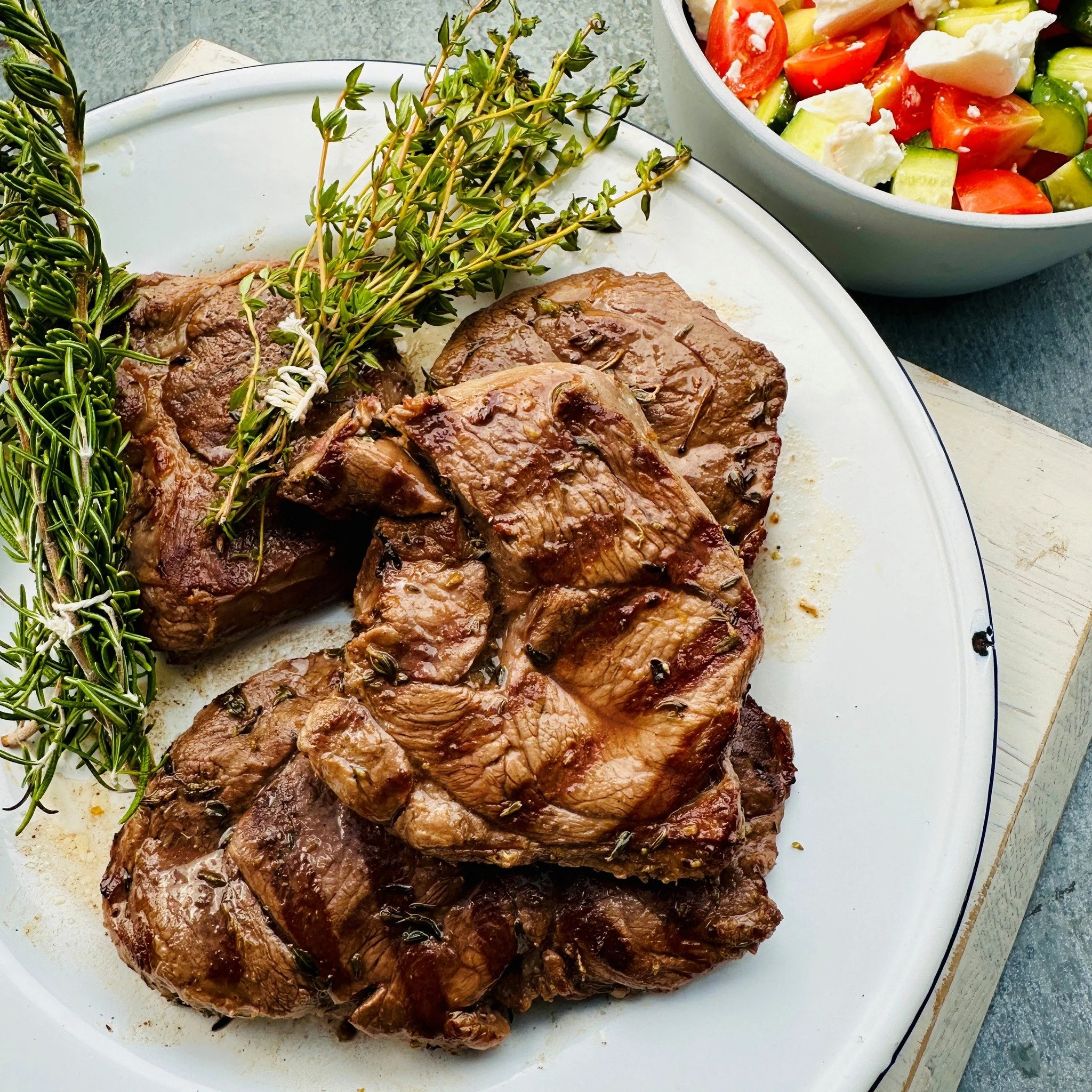 With plenty of barbecue weather heading our way this week, @fionahammondfood's  recipe for our lamb leg steaks, marinated in a herby flavoured mix of lemon juice, olive oil and rosemary or thyme, are just so tasty and affordable ❤️ Served with a Gree
