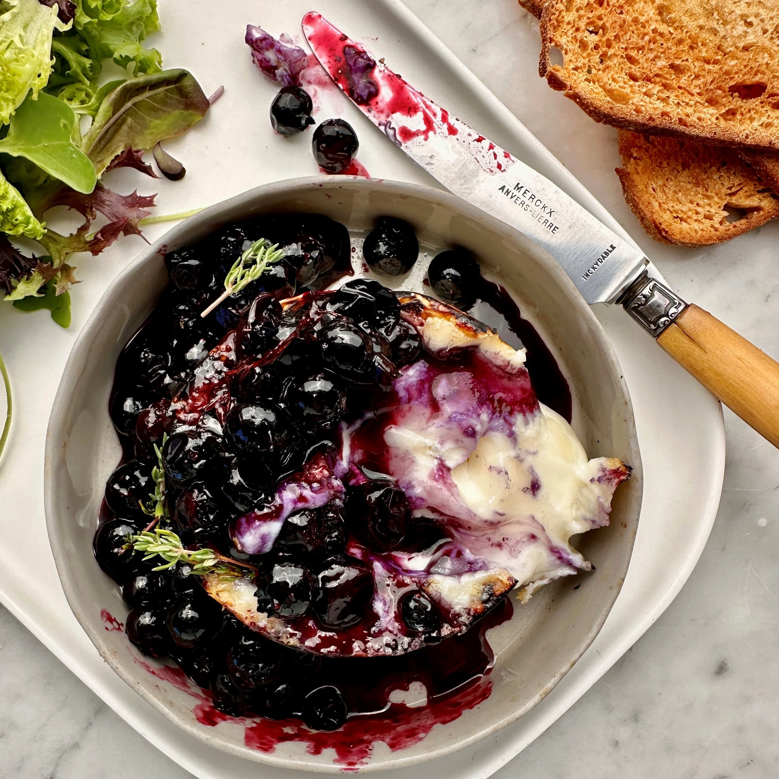 BAKED CHEESE WITH WARMED BLUEBERRIES, THYME AND HONEY