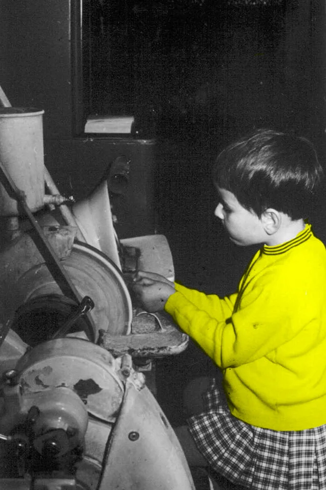 Catherine, Nicolas’ mam – 5 y.o. - hand-shaping mineral lenses in the workshop after school, back in 1969. She hasn’t really left the workshop since!