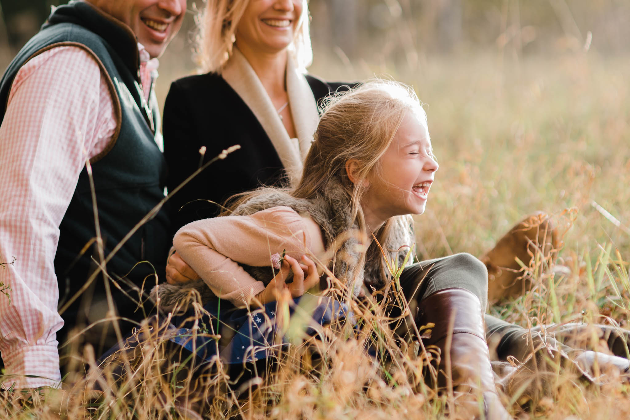 Family of three lauging in fiekd- Cotswold Family Photoshoot.jpg