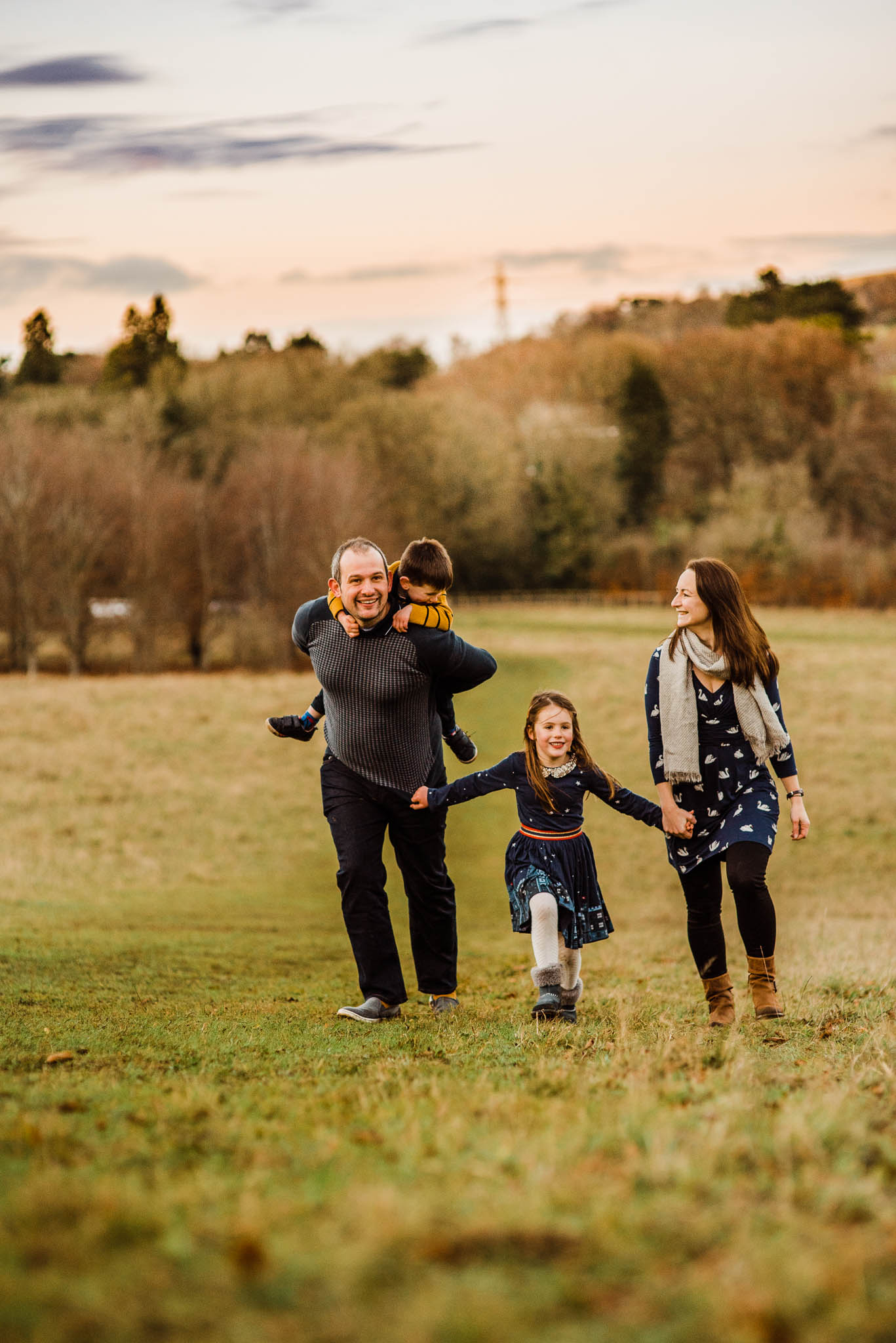 Family running in field- Cotswold Family Photo.jpg