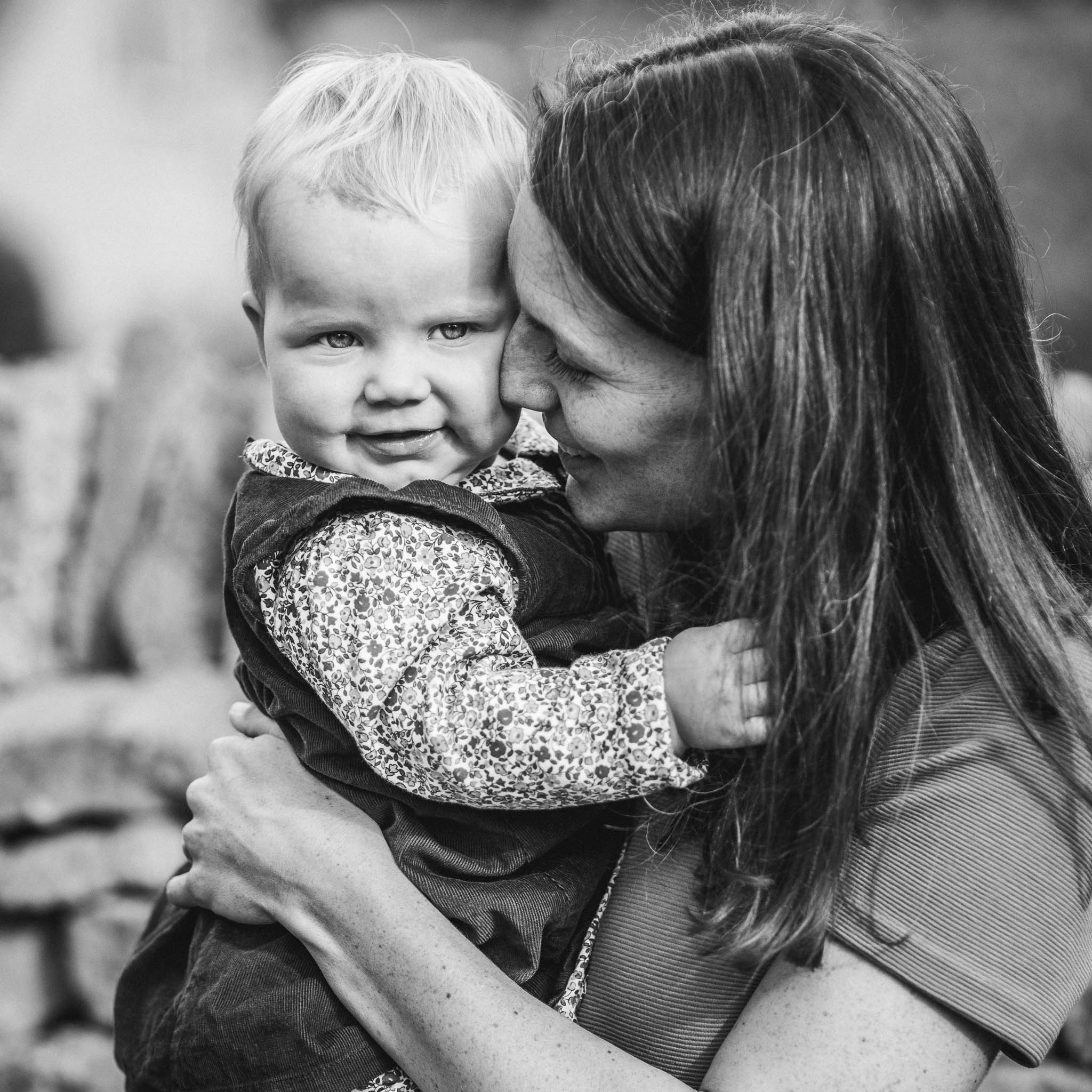 Mother cuddling toddler outdoor photography Cotswolds.jpg