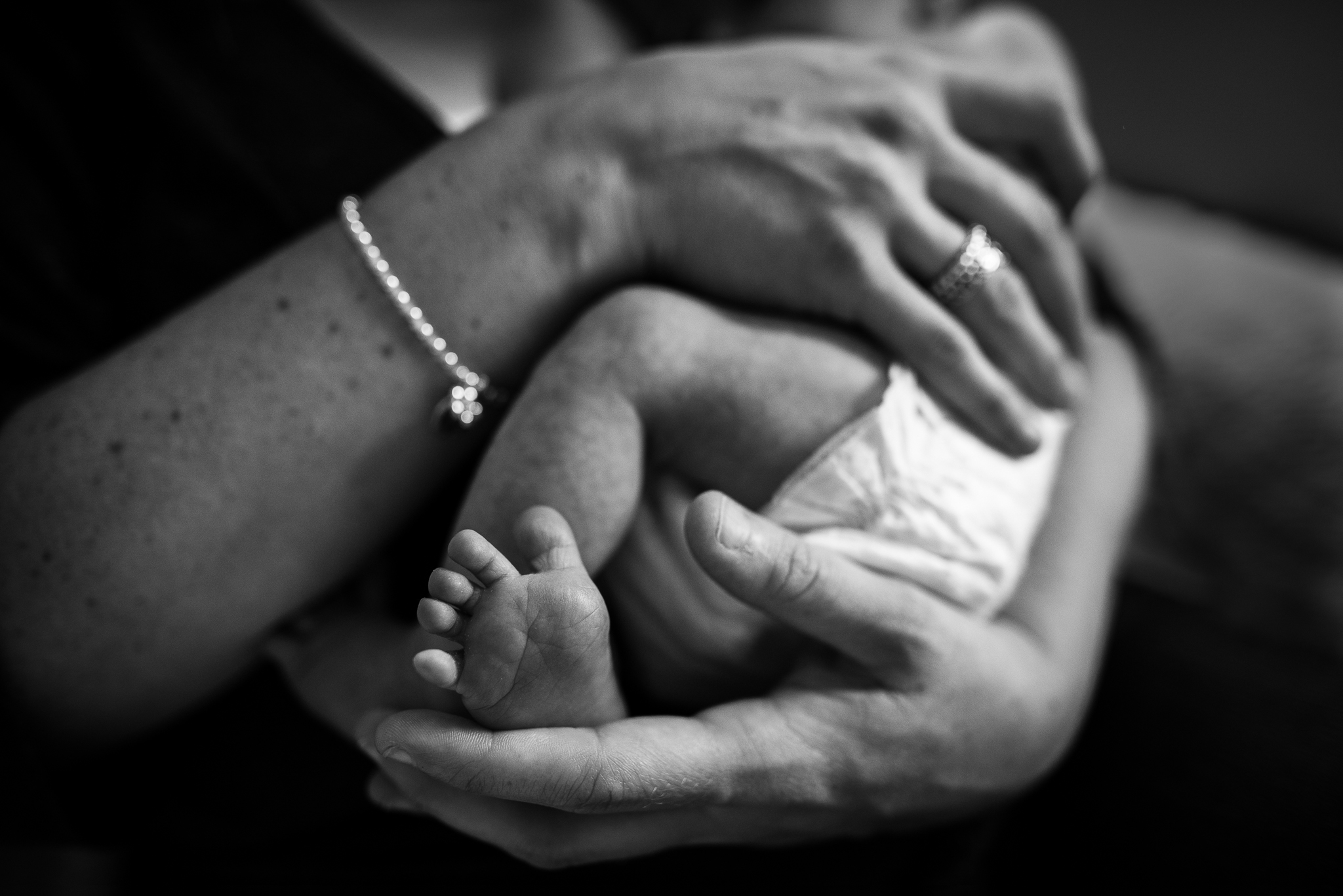 Tiny baby in mothers arms at home_Cheltenham Newborn Photographer .jpg