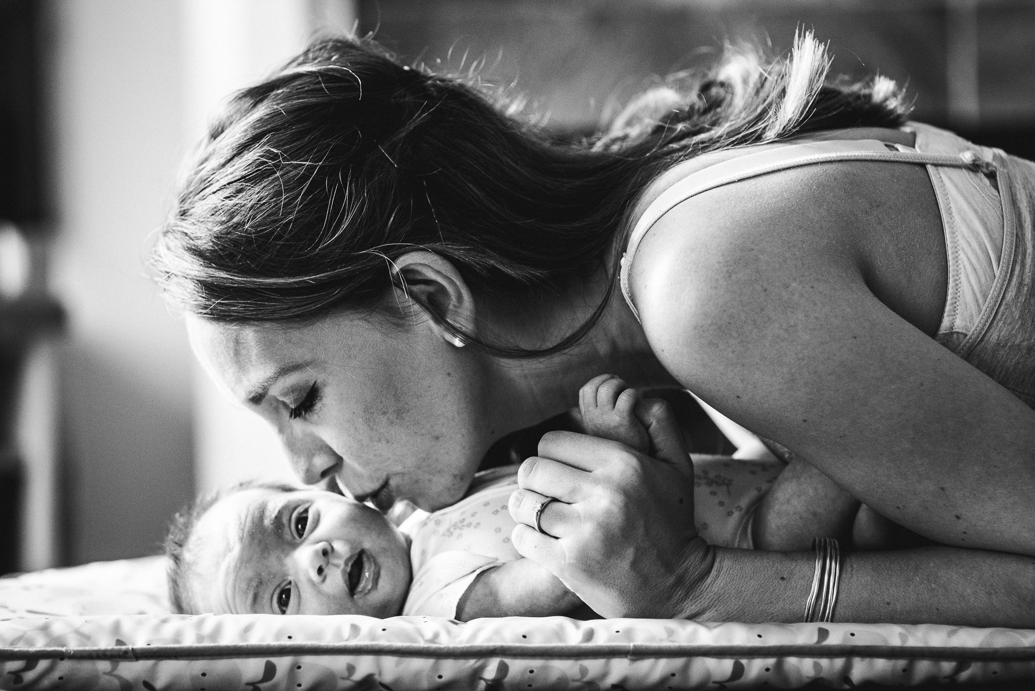 Mother kissing newborn baby Cheltenham Newborn Photorapher.jpg