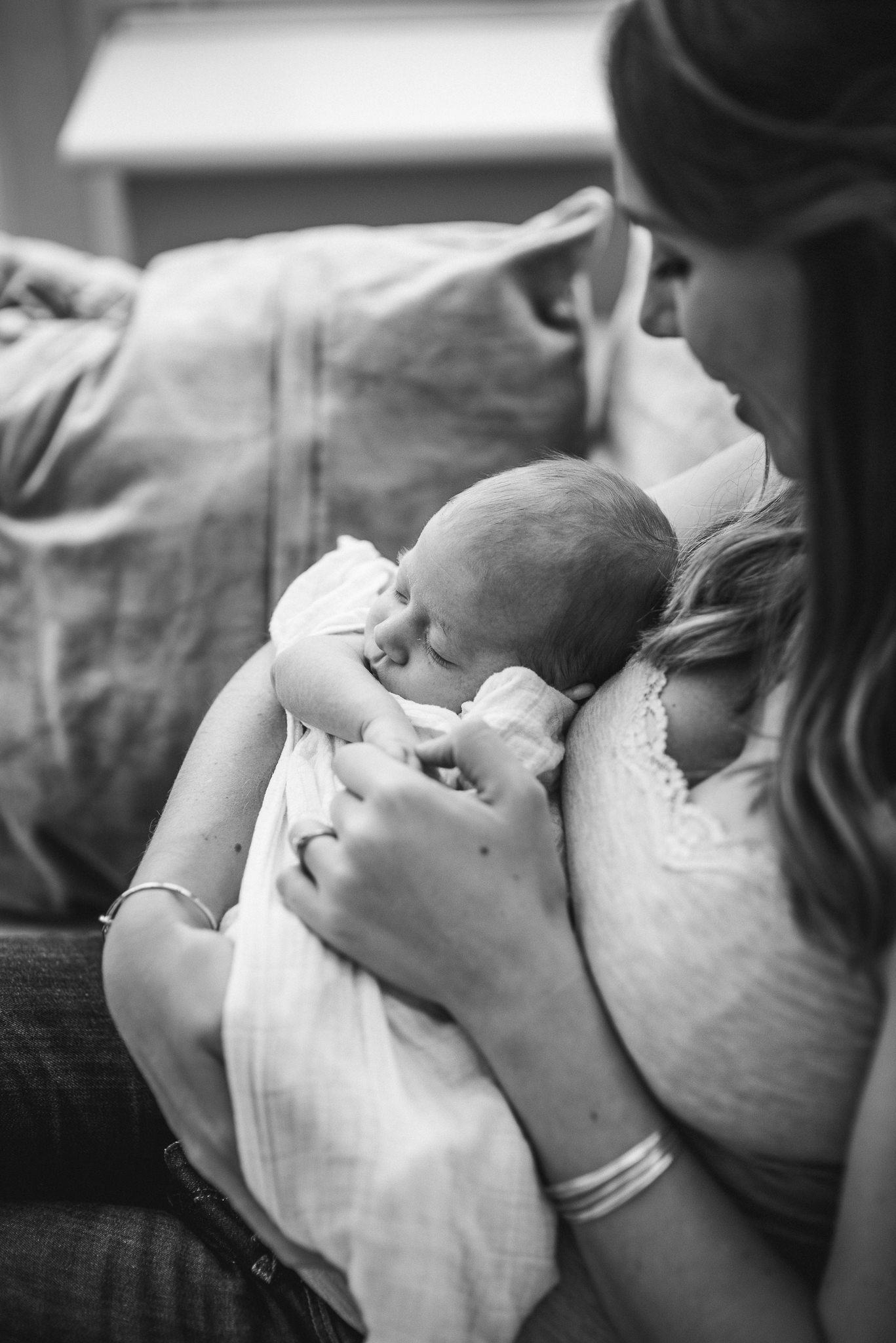 Newborn baby sleeping in mothers arms Cheltenham Newborn Photo.jpg