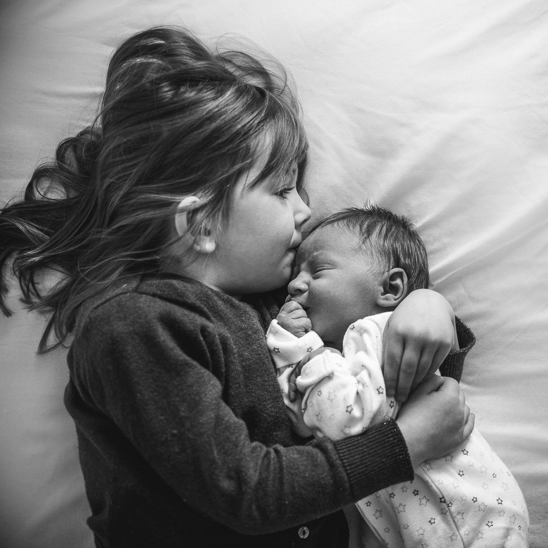 Little girl kissing her baby brother - Cheltenham photograph.jpg