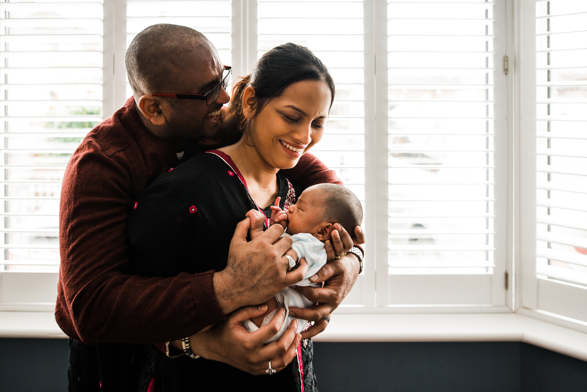 Happy new parents at home with newborn.jpg