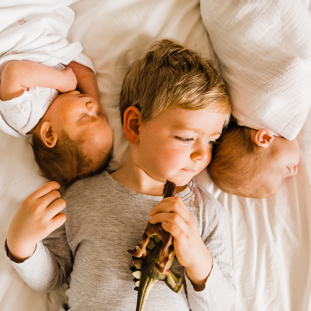 Cute Toddler boy with newborn twins in home photoshoot- cheltenham family photographer.jpg