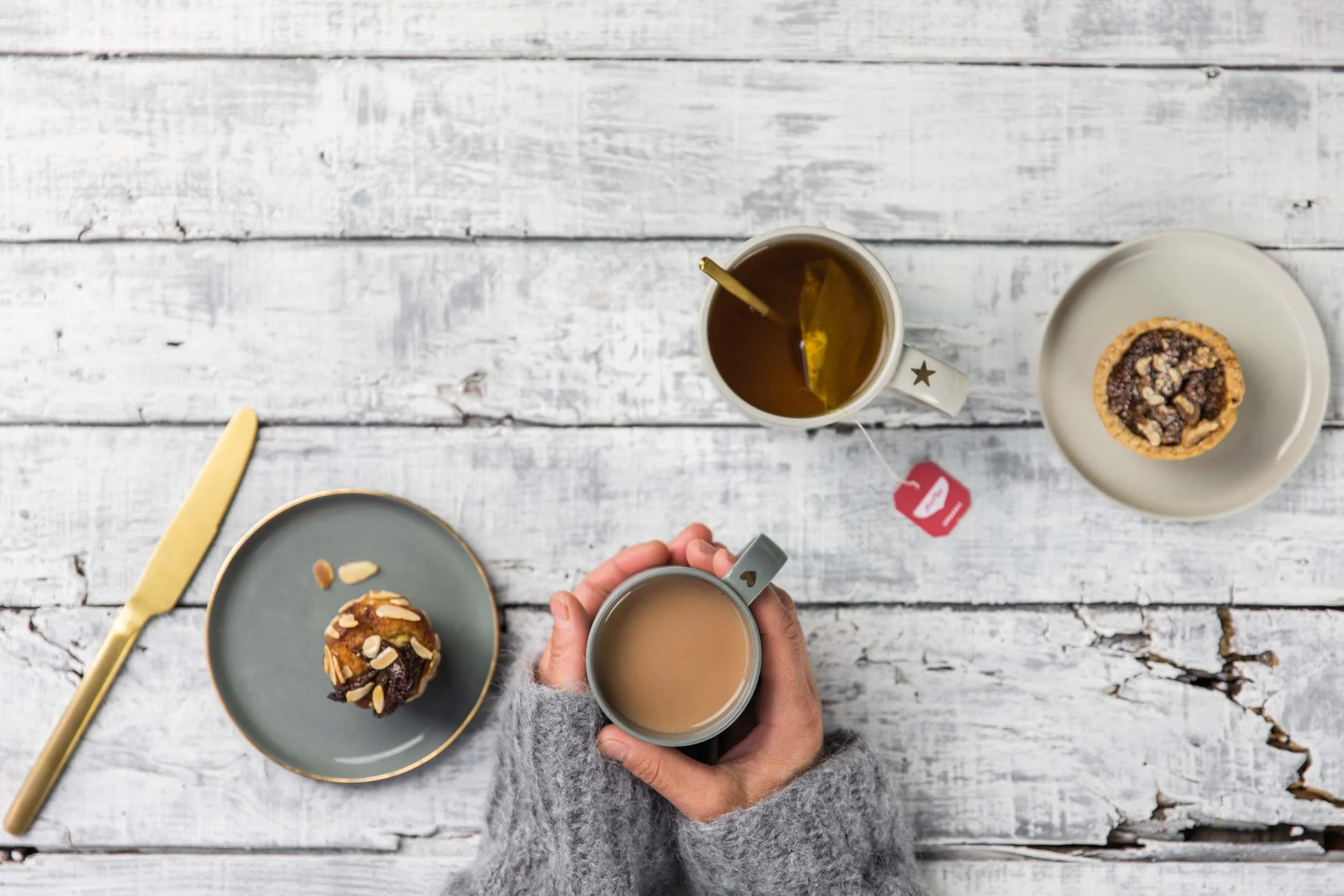 mug of tea in hand at table