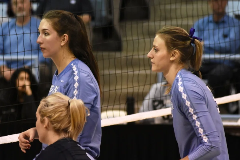 Beth Nordhorn, left, and Taylor Fricano, with libero Casey Jacobs in the foreground.