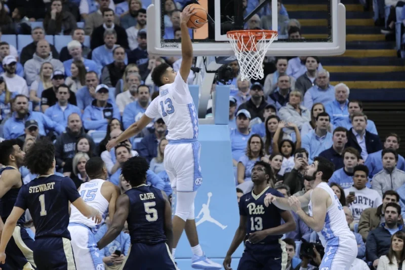 Cam Johnson (13) had a rough day from the floor, but his first made attempt was a one-handed baseline slam that energized the Smith Center crowd. | Photo by Caleb Jones