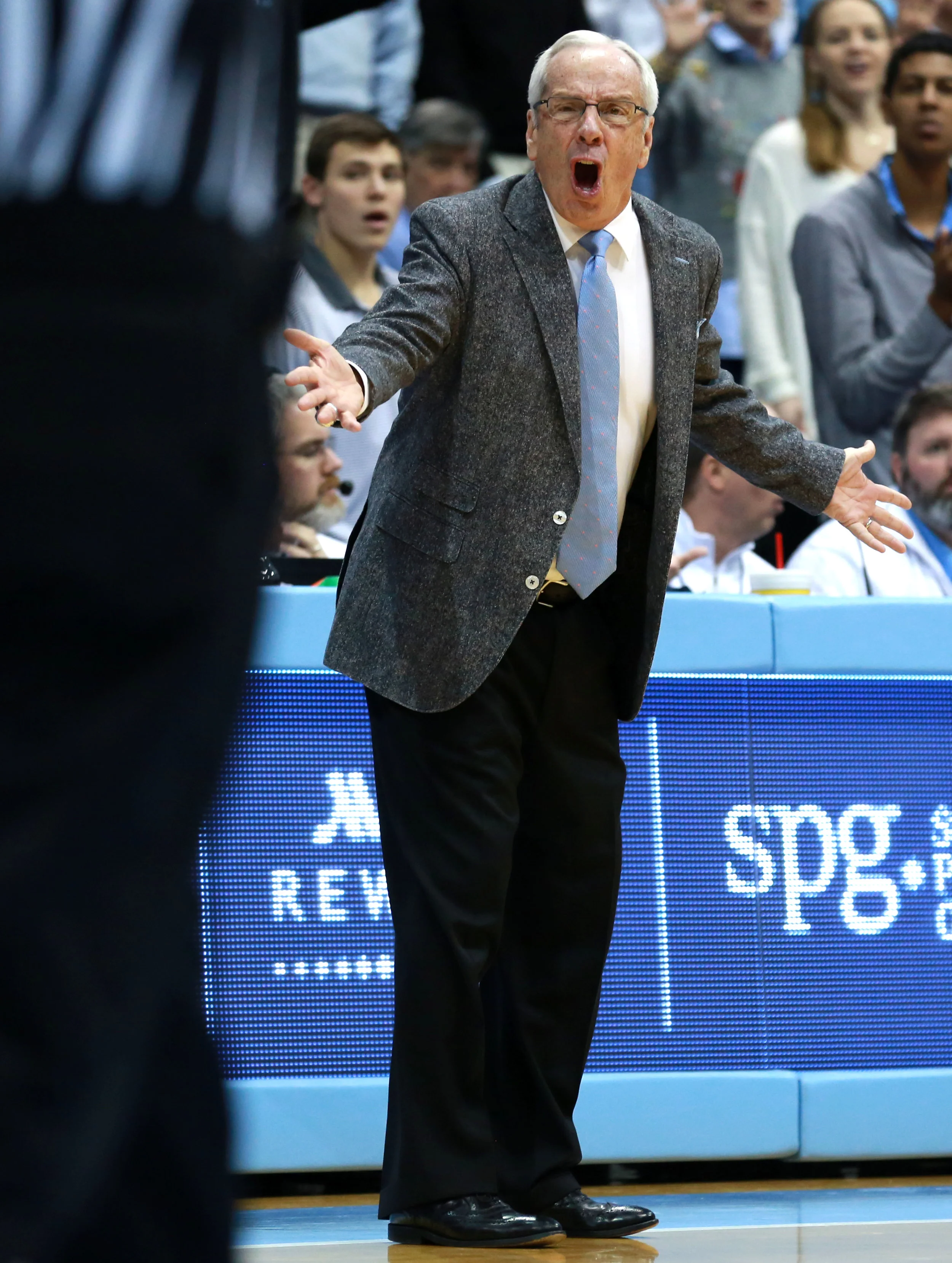 Roy Williams attempts to get a referee’s attention during Saturday’s loss to Louisville. The Hall of Fame coach suffered his worst home defeat of his Carolina head coaching career against the Cardinals. | Photo by Alex Kormann