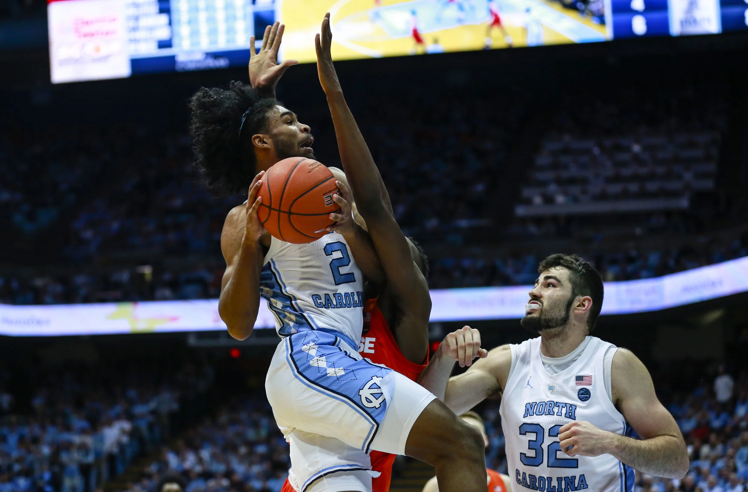 Freshman Coby White drives into the teeth of Syracuse’s 2-3 zone. The freshman had 34 points on Tuesday night, becoming the first ever freshman at Carolina to have three 30+ point games (Texas, Miami) | Photo by Alex Kormann