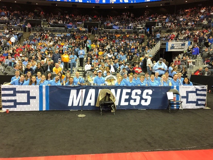 The UNC pep band smiles from their designated area along the baseline as they wait for halftime to end of North Carolina’s Round of 32 game. (Photo courtesy of Jeff Fuchs)