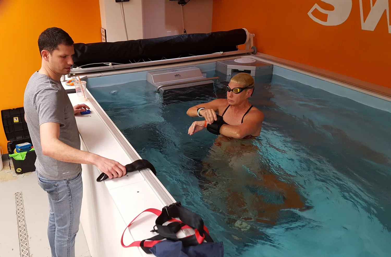 Dominic Latella coaching a swimmer through a movement at SwimBox