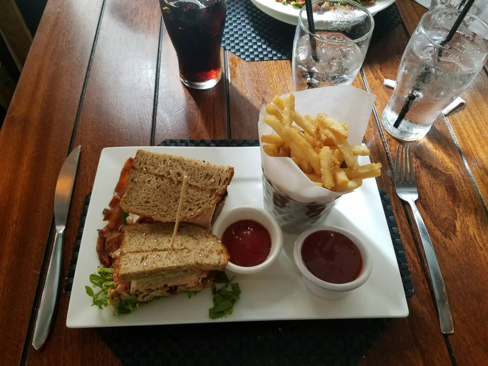 The Salmon Club with watercress, tomatoes, bacon, avocado and pesto aioli.