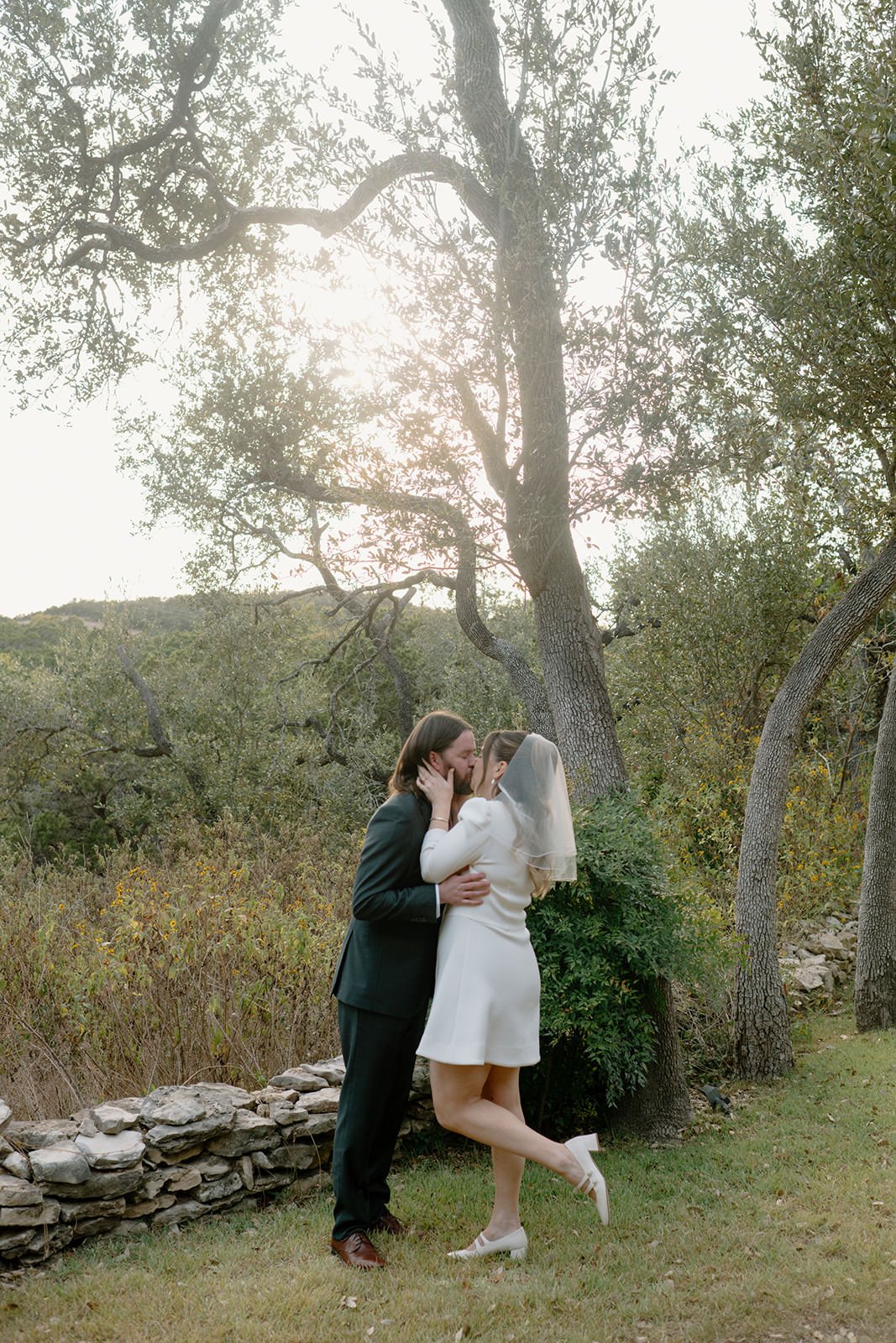  A newlywed couple during their first kiss at their wedding ceremony  