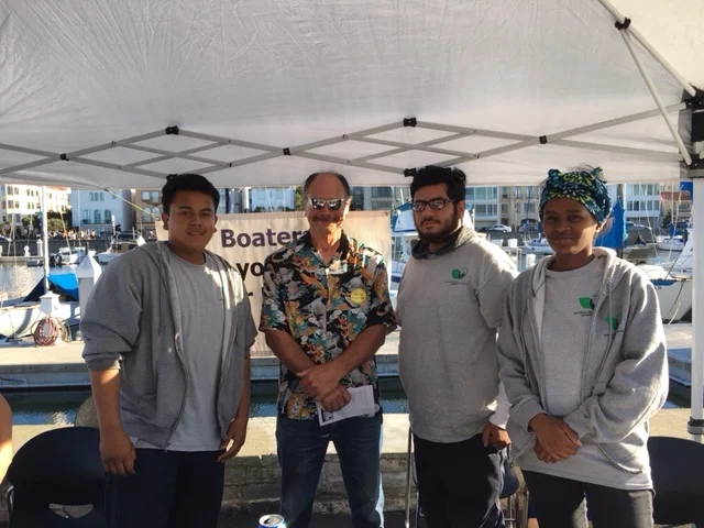 Corpsmembers (from left) Chris, John, and Issis, with Dock Captain Ed. 