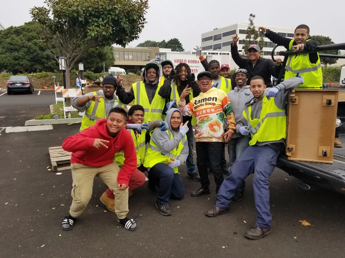 Corpsmembers stop to take a picture with a community member with the coolest hoodie!