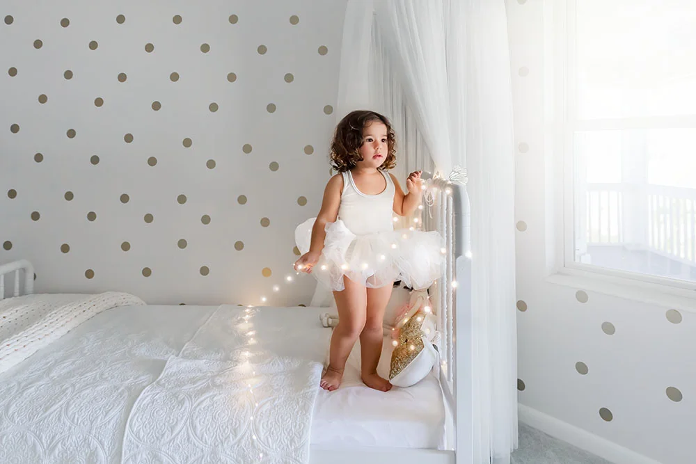 Part of the bright and airy feel is the light colored clothing, and environment. Also light and airy needs light and here she is beside a window and glass door.