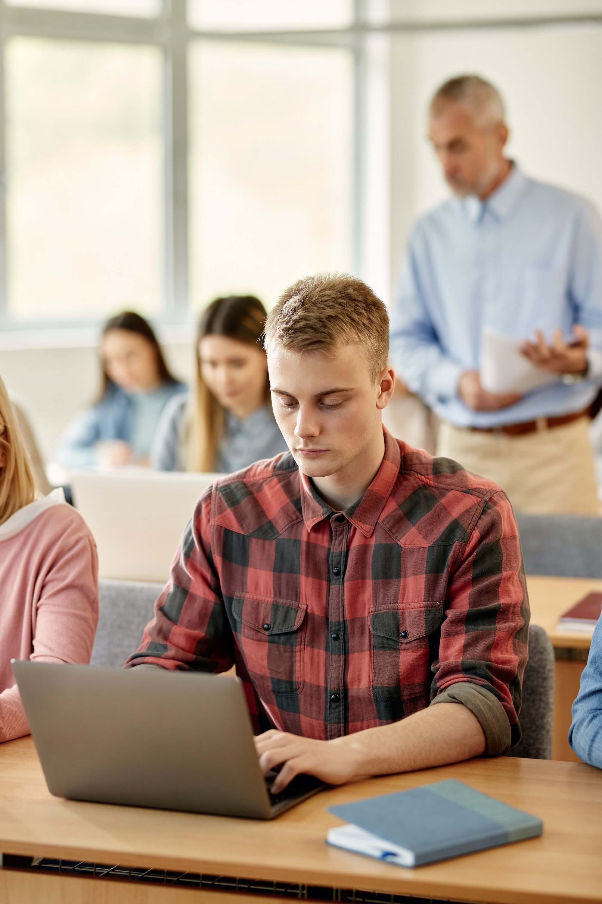 A man sitting at desk on a laptop