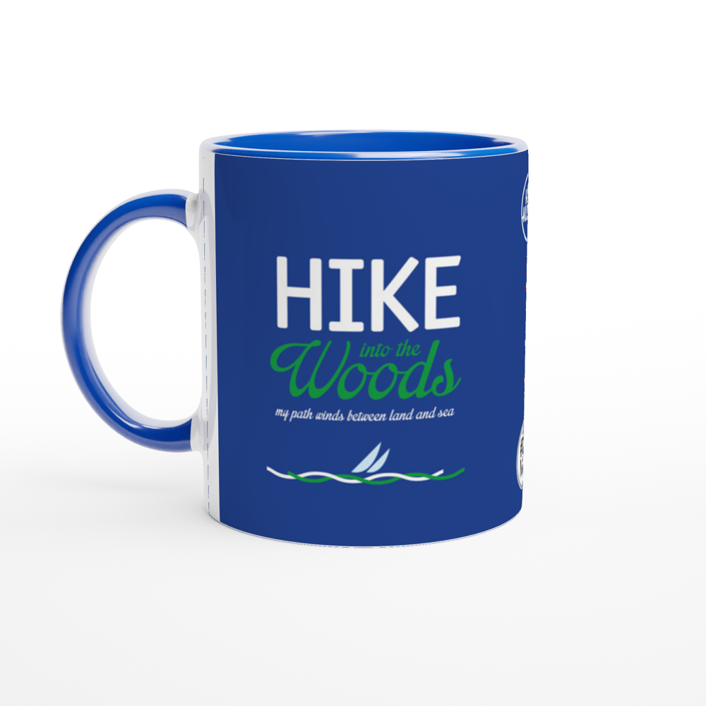 The picture shows a right side view of the 11oz ceramic mug "HIKE INTO THE WOODS" from the series HIGH COAST SAILOR #TAGMUG™ with blue color inside