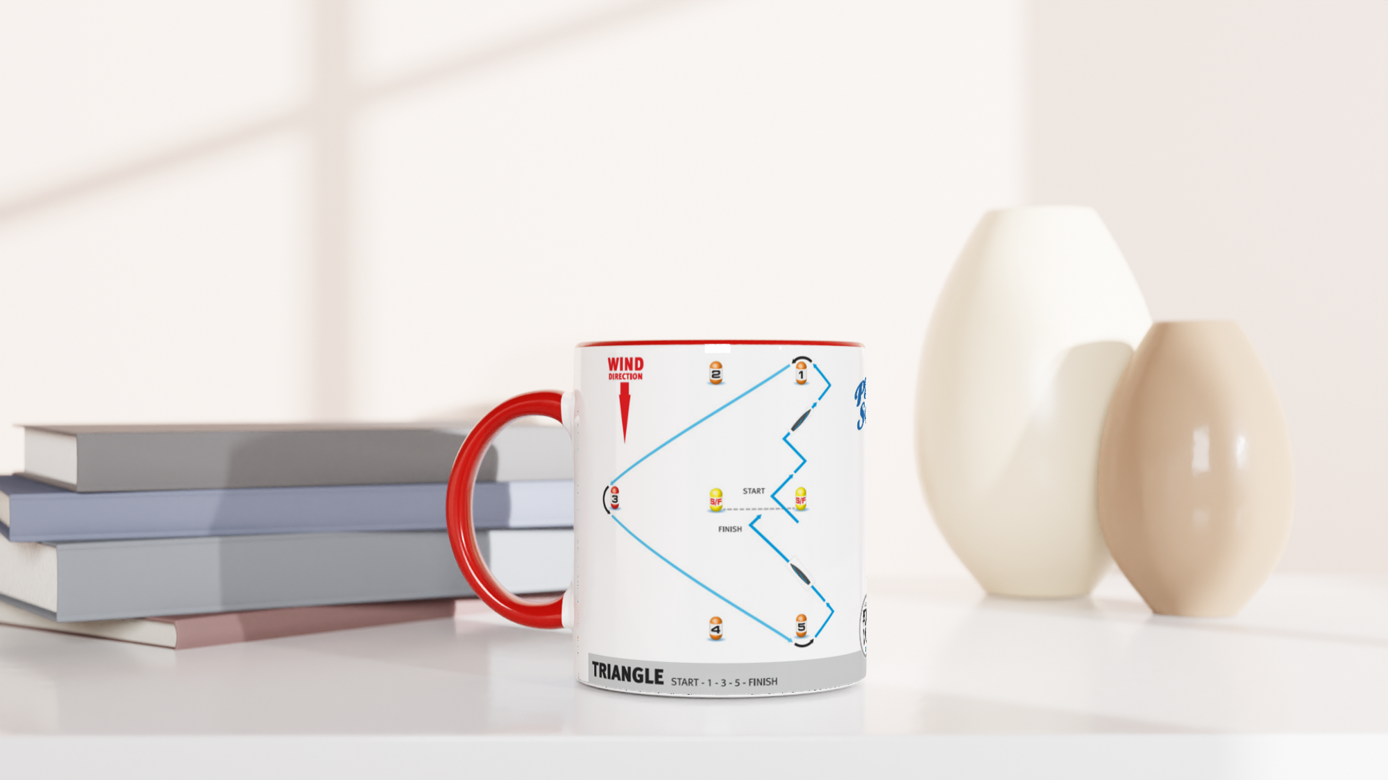 The picture shows a left side view of the 11oz ceramic mug “SAILING COURSES 2” from the series “Play2Sail: Radio Sailing Academy #DF65” [#TAGMUG™] with red color inside on a desktop
