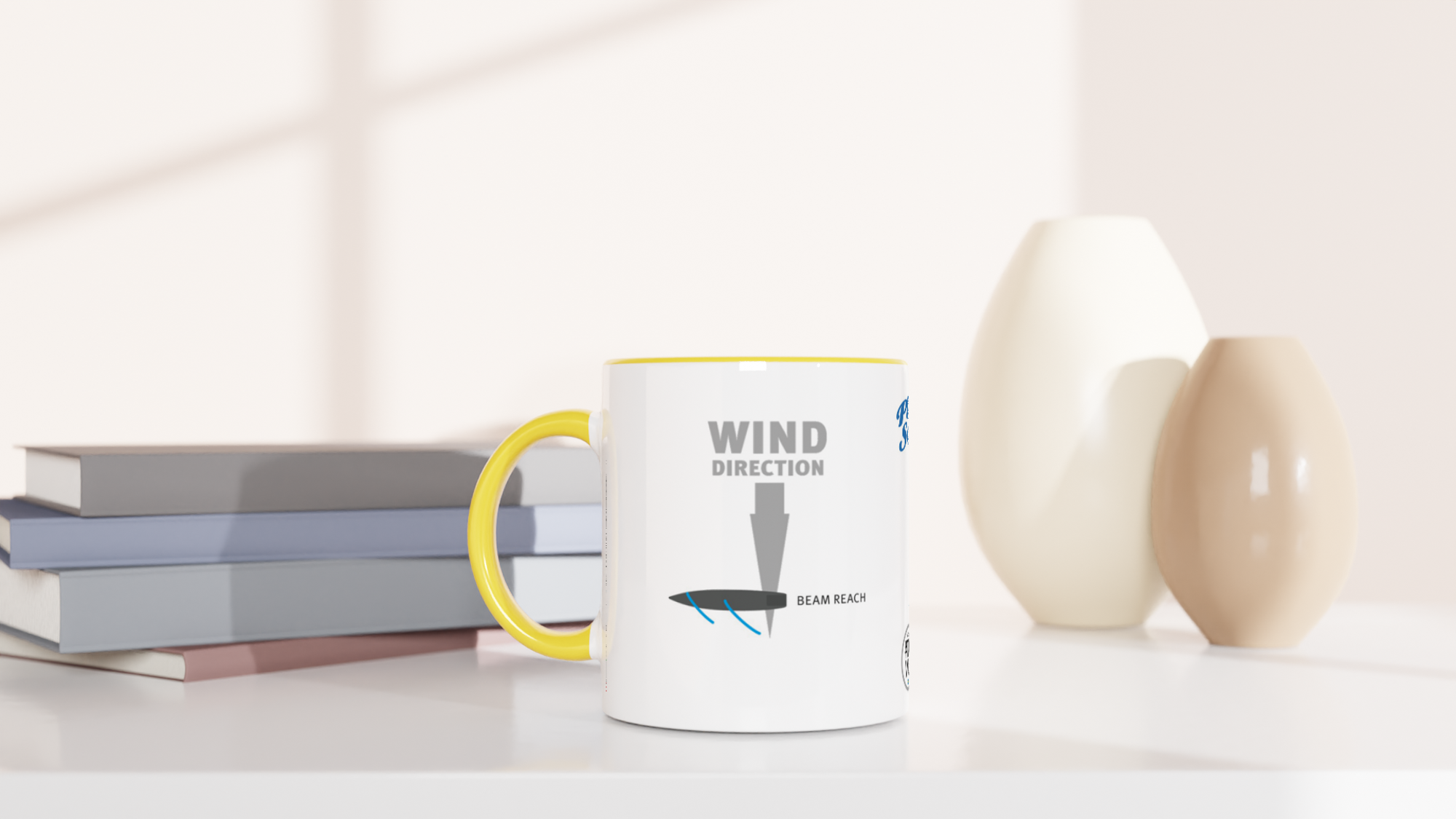The picture shows a left side view of the 11oz ceramic mug "POINTS OF SAIL: BEAM REACH (4)" from the series SAILING #TAGMUG™ with yellow color inside on a desktop