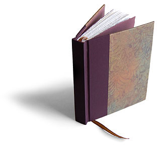 One-of-kind paste paper, cotton paper pages with hand torn edges and a ribbon marker make this book a special keepsake.