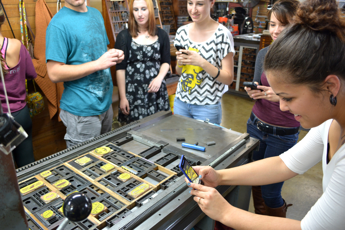 The first print rolling off the press always makes a good photo op.