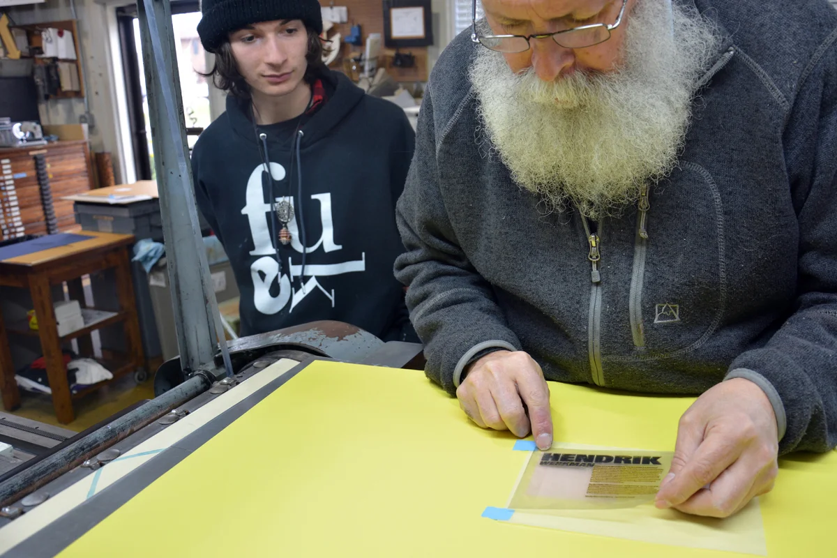 Positioning the photopolymer plate so it will be in the desired place once it adheres to the base.