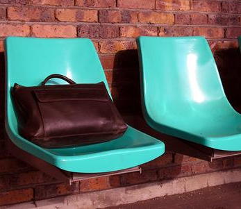 Train passenger with bag on seat definitely better than me
