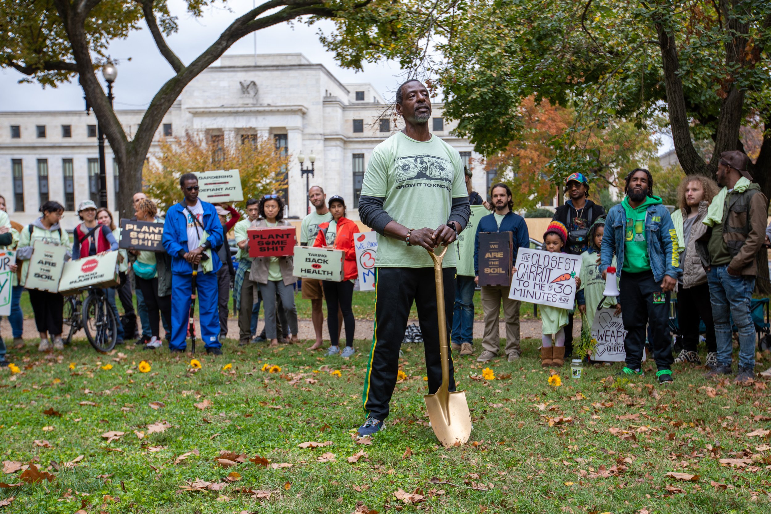  Ron Finley, the gangster gardener, at the Constitution Gardens in D.C. in front of the Federal Reserve building about to plant the first Ron Finley currency. These biodegradable bills once planted on soil can actually grows into fresh produce.  // l