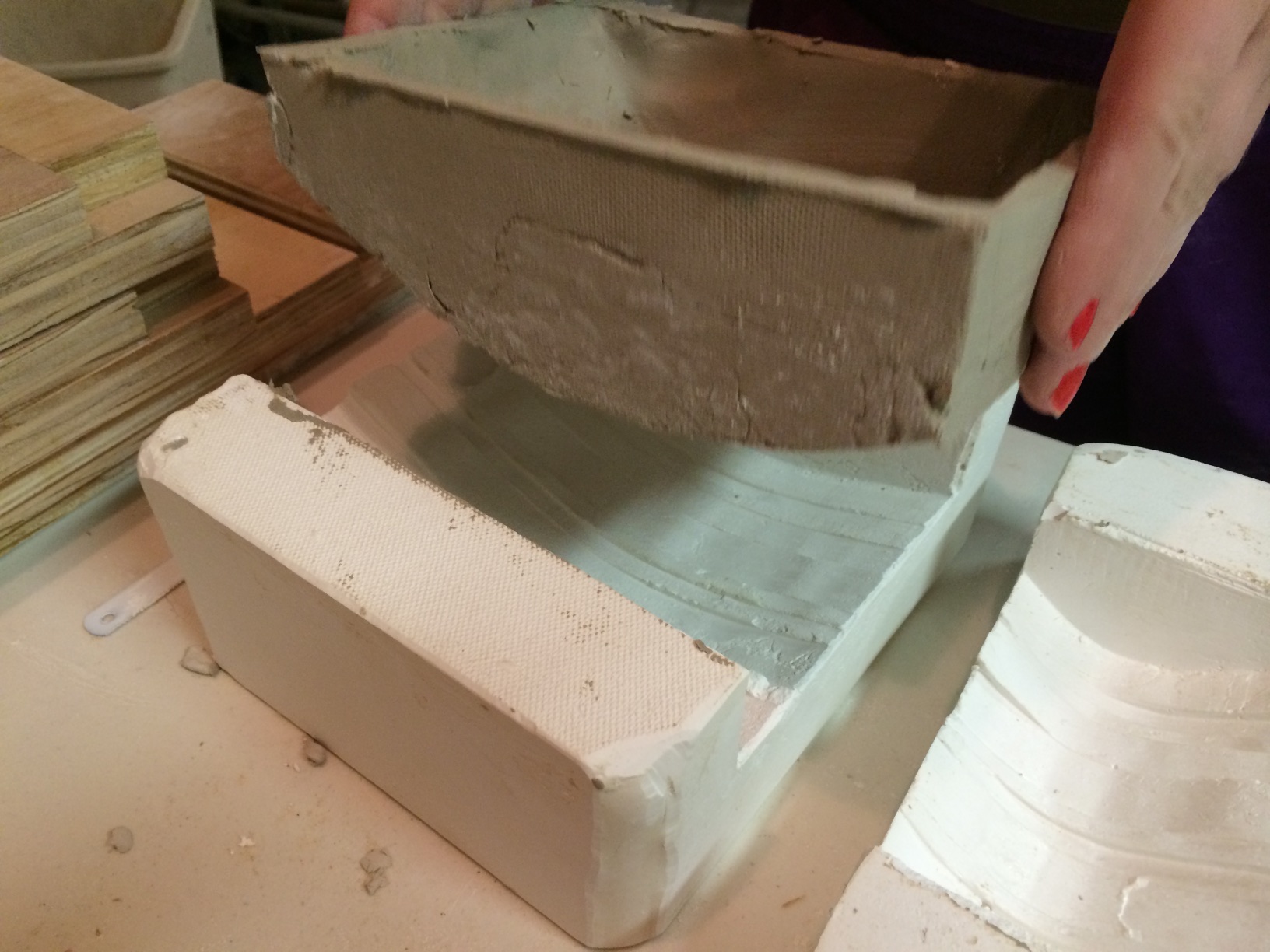  Removing a tile from the plaster mold. 