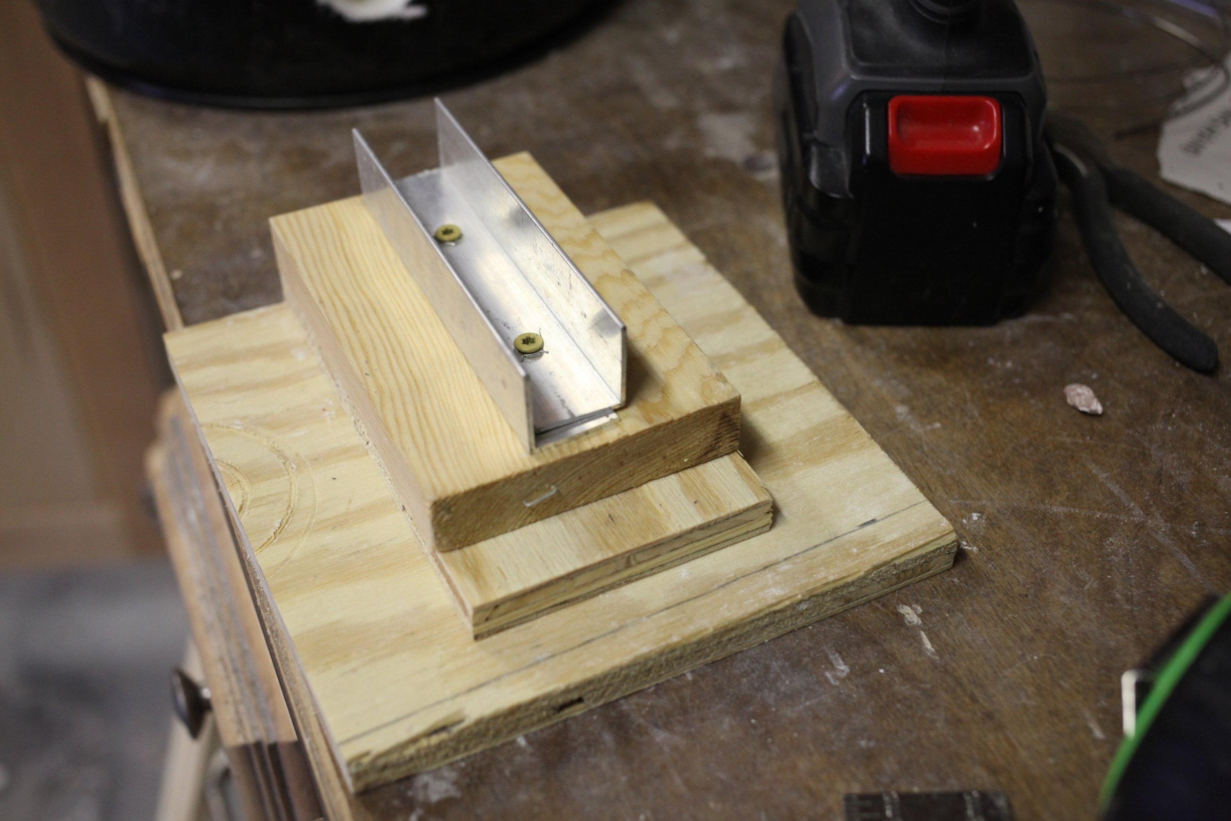  A wood and metal jig to hold the burner. I would  not  recommend using any wood for this.&nbsp; 
