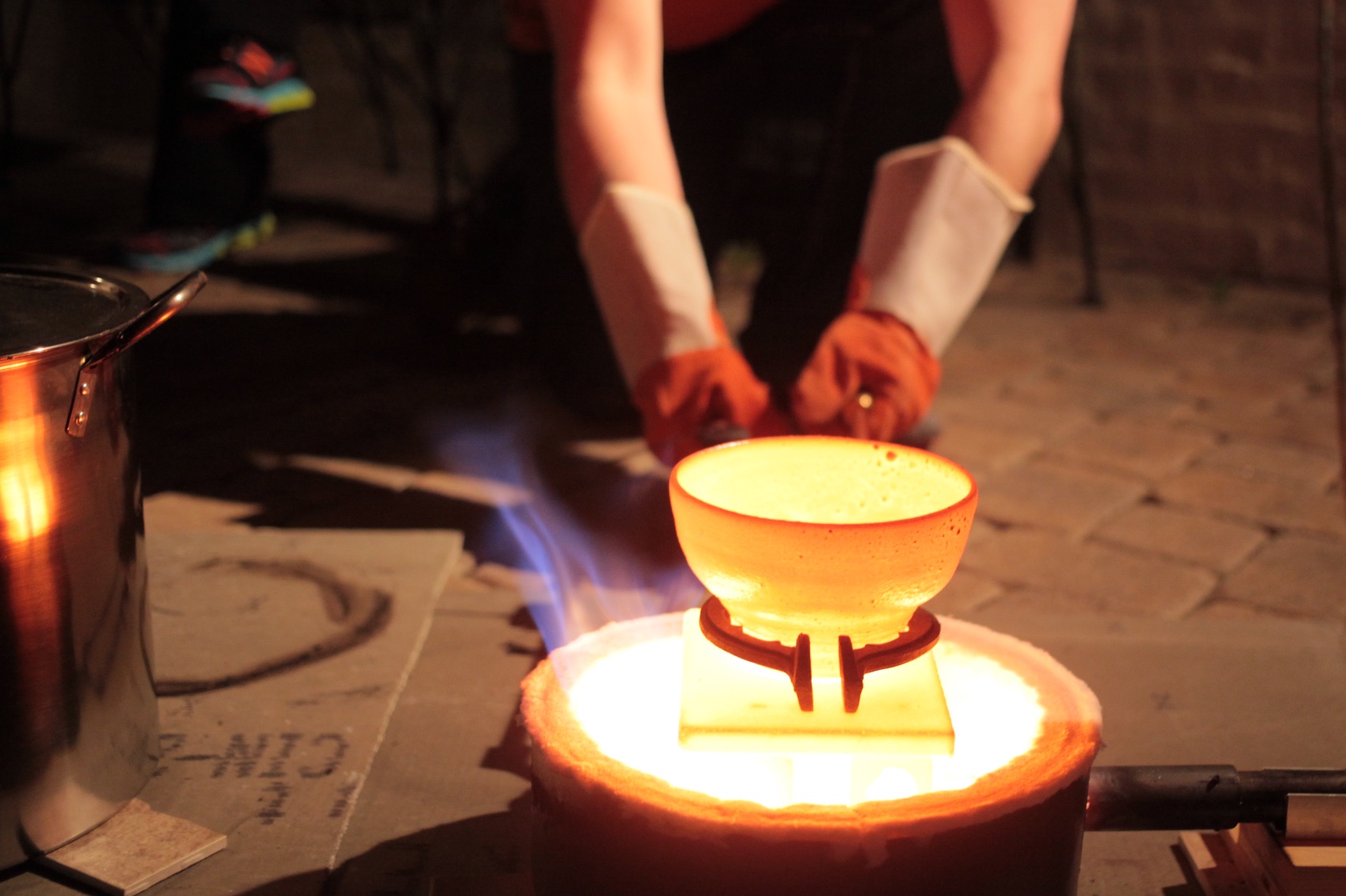  Once a piece is at full temperature,  carefully &nbsp;remove the lid (wearing heavy welding gloves), and have a second person lift the pot with tongs (we used old fireplace tongs from a thrift store).&nbsp; 