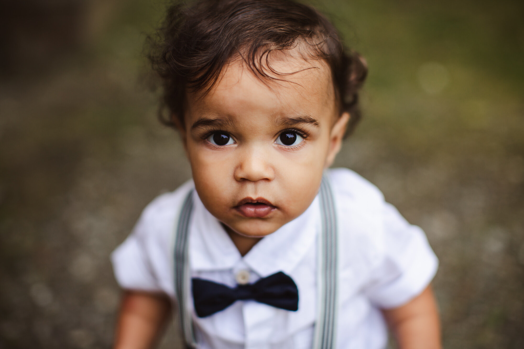 Alaska Family Photographer, close up of little boy with suspenders and a bow tie