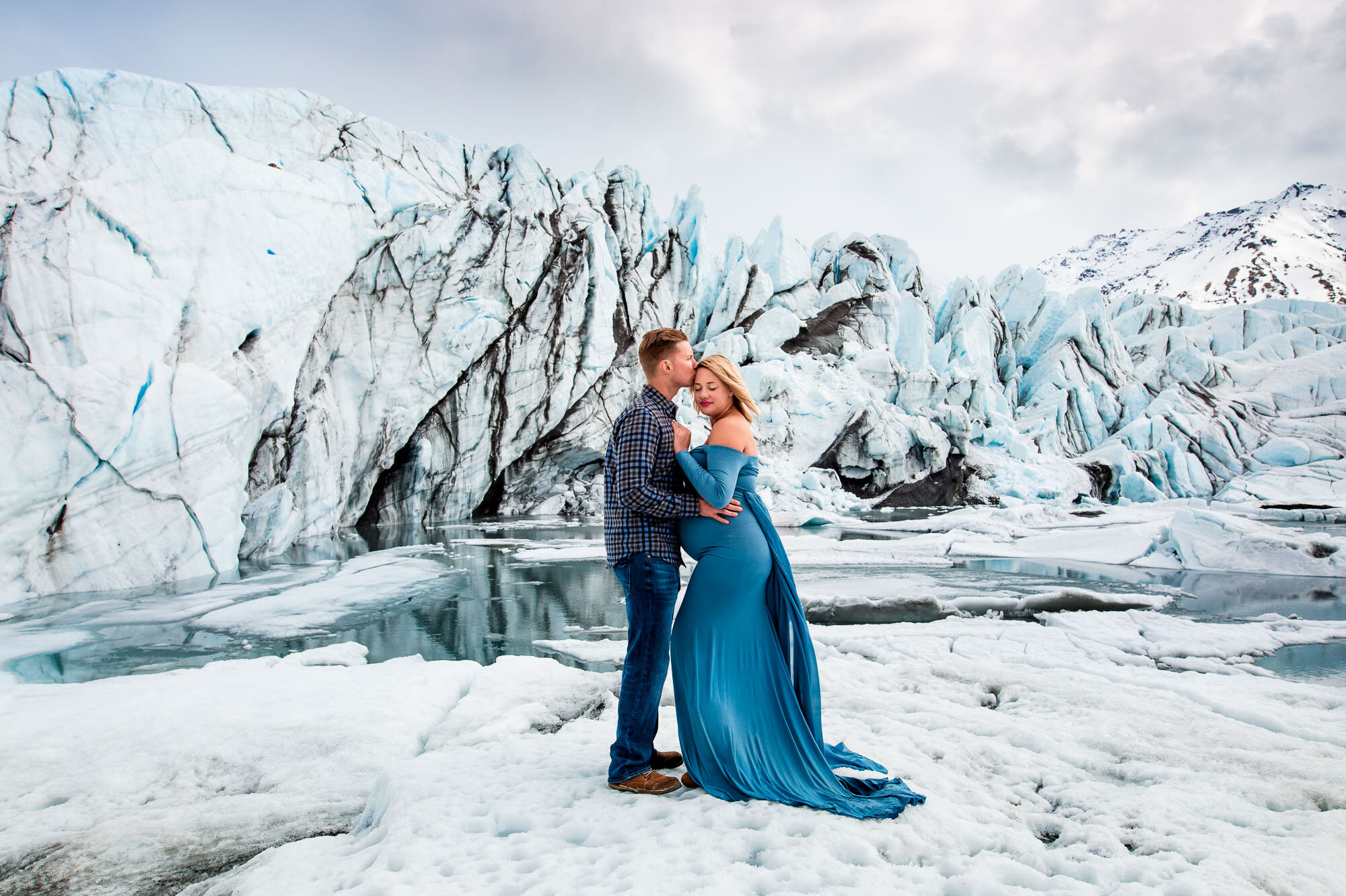 Alaska Family Photographer, couple standing together in the snow with icy landscape behind them (Copy) (Copy)