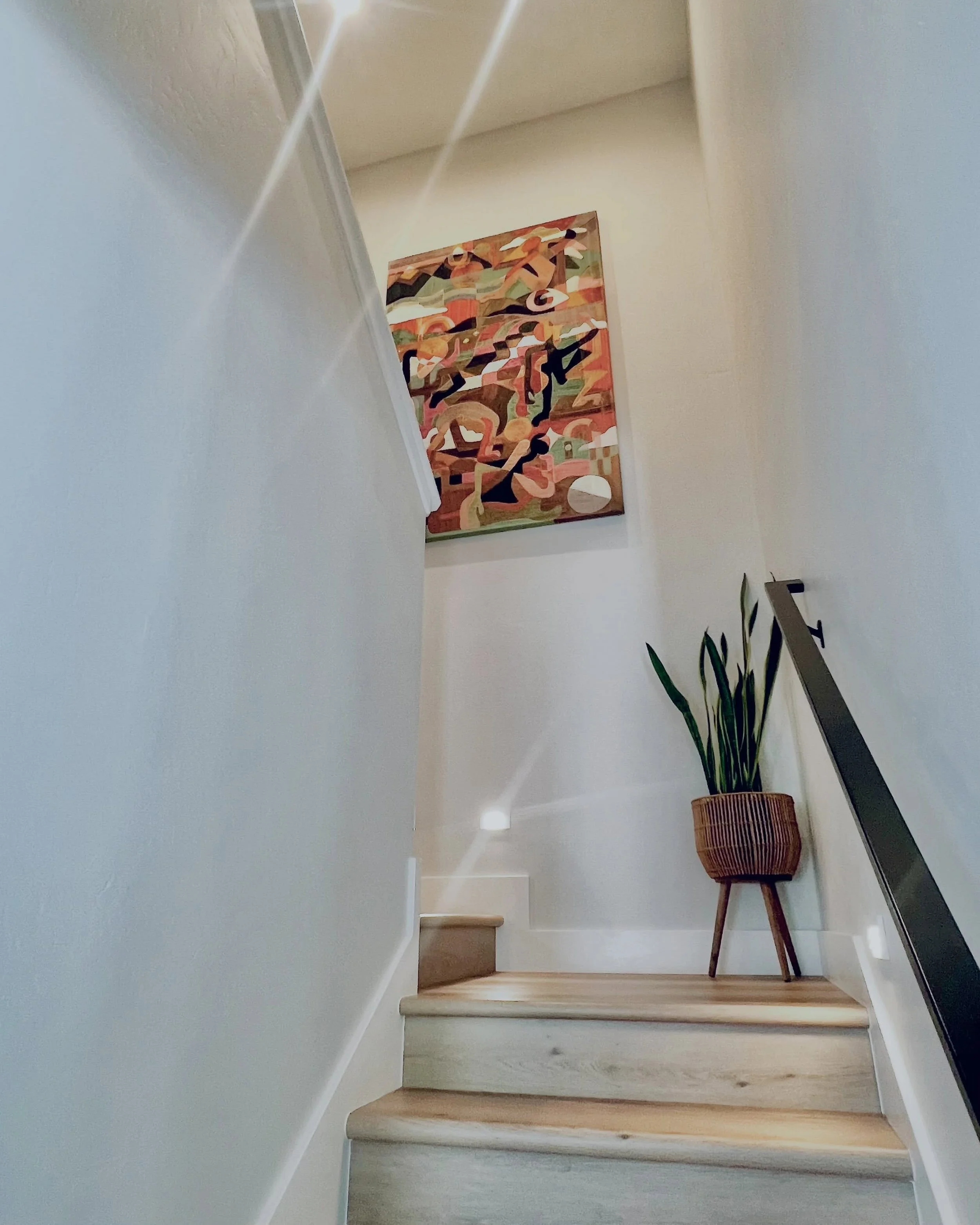 A scenic view going up the stairs.
&lsquo;Somewhere Out There&rsquo; (70&rdquo; high x 46&rdquo; wide) has been installed on the perfect switchback staircase wall. Thank you Shelley &amp; Andy! 🖤 And TY @theblackpiglet for showing this artwork durin