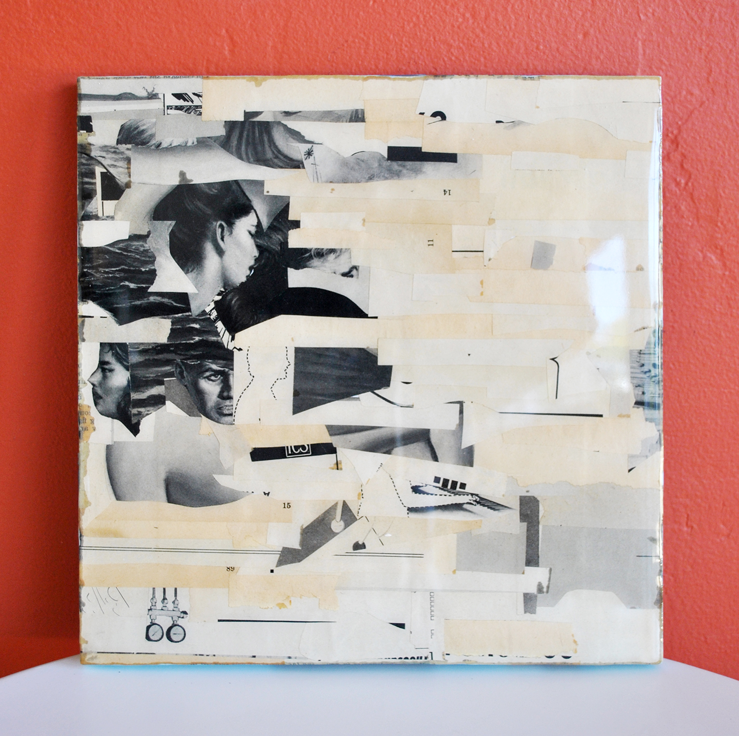 old magazine scraps on recycled particle board, coated in resin