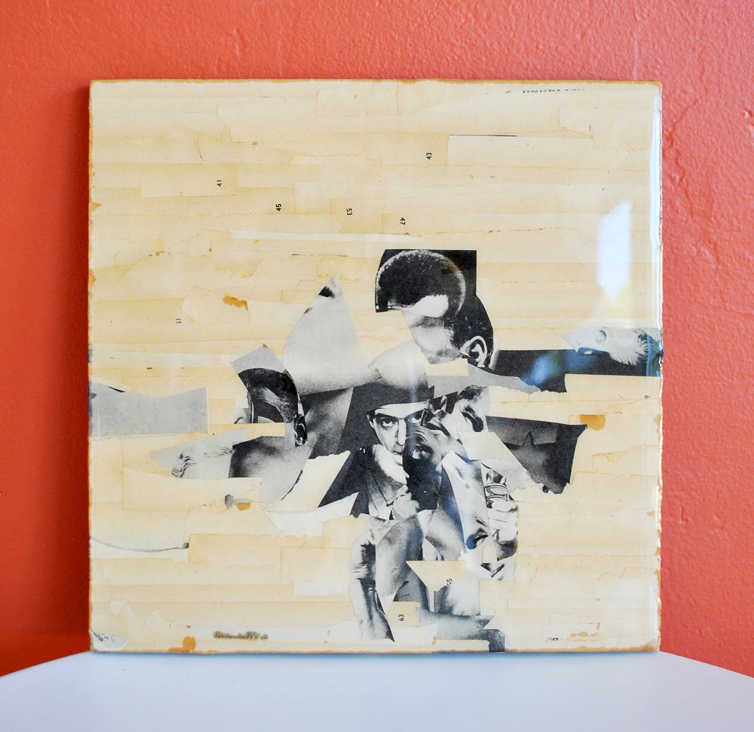 old magazine scraps on recycled particle board, coated in resin