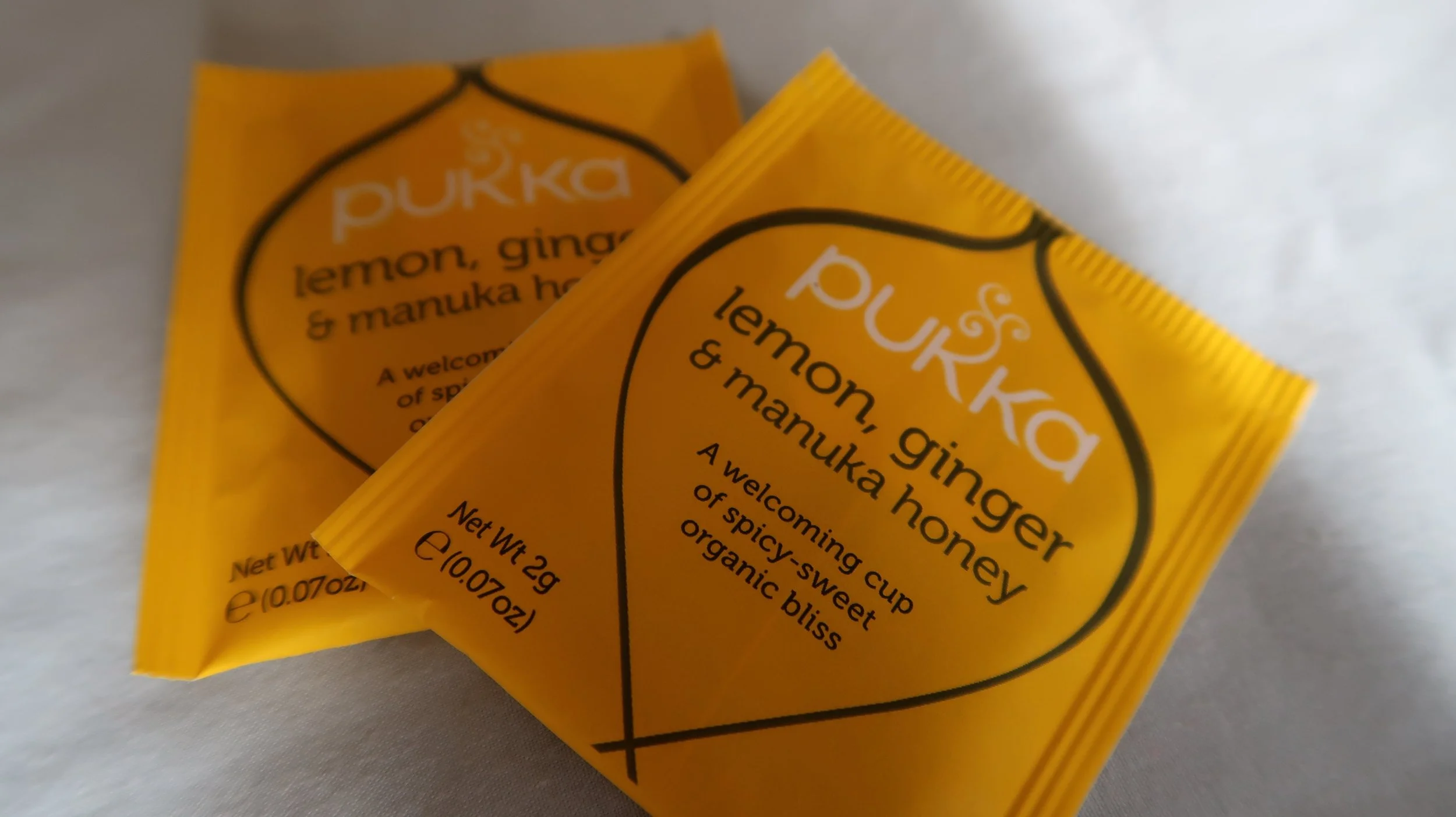 There are lots of herbal teas which contain ginger, alternatively you could just add ginger root to hot water.