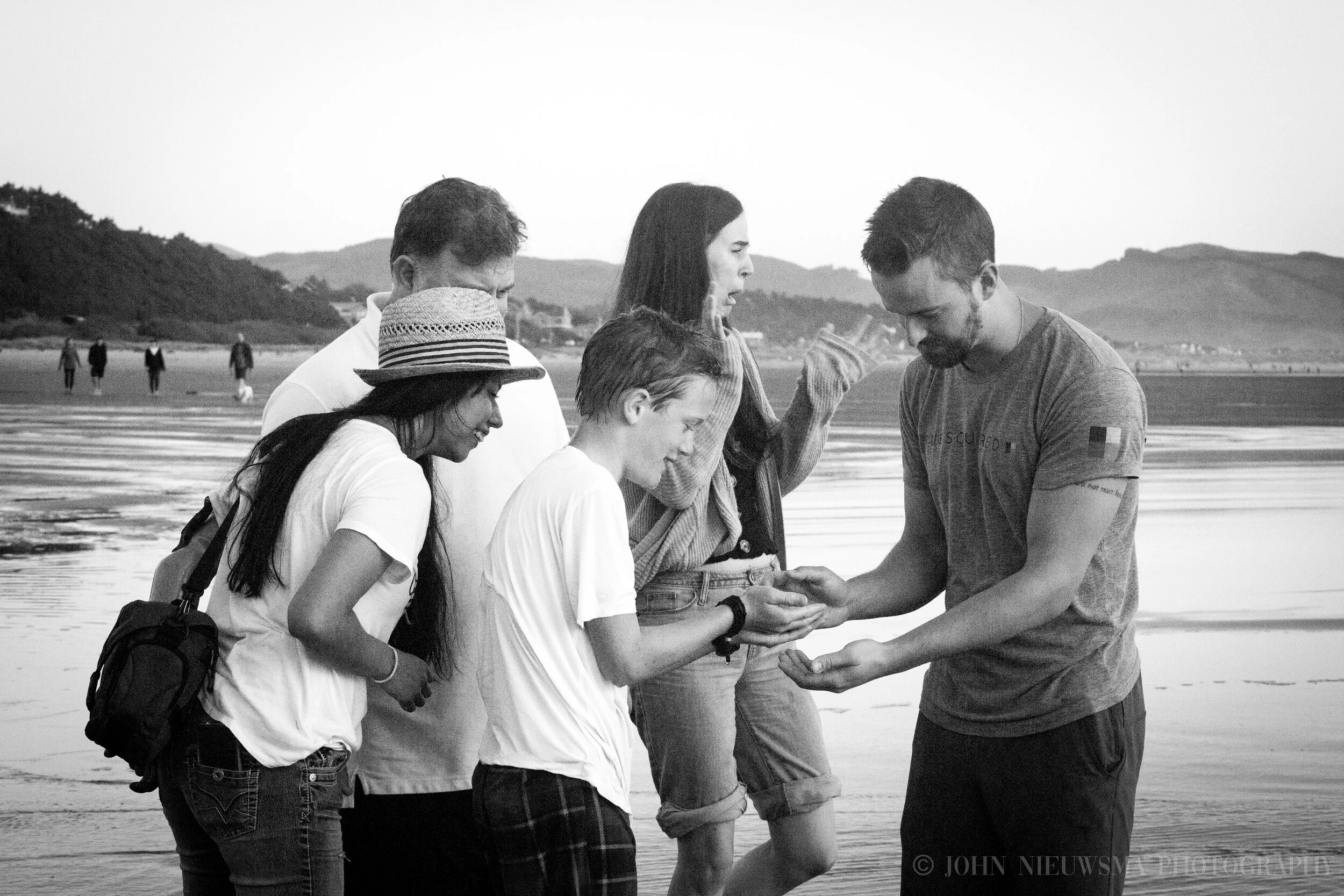Ted and Thomas inspect a specimen, Deborah and Dad peer over curiously, Kara recoils