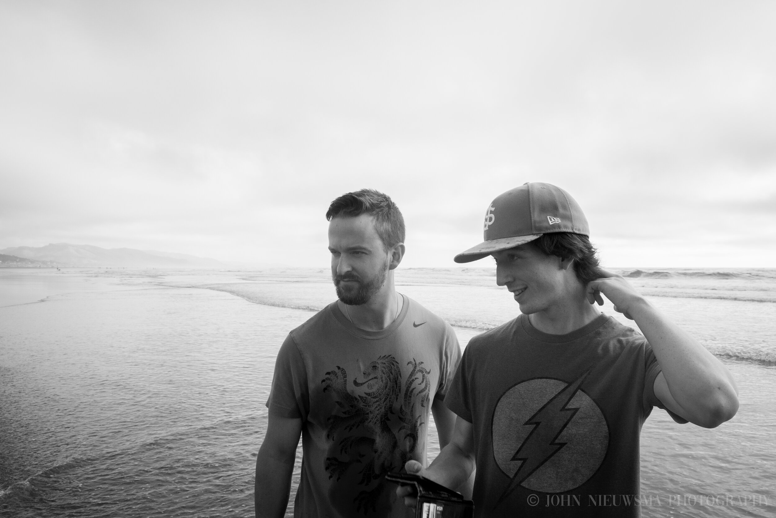 The brothers whisper together, Andrew checks his phone, Ted stares intently