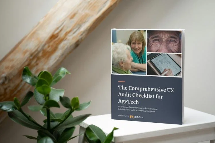The Comprehensive UX Audit Checklist for AgeTech standing on a white shelf beside a plant