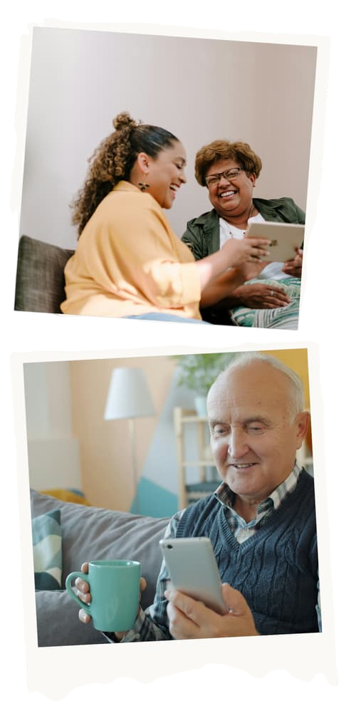 An adult daughter and her mother laughing together while looking at a tablet