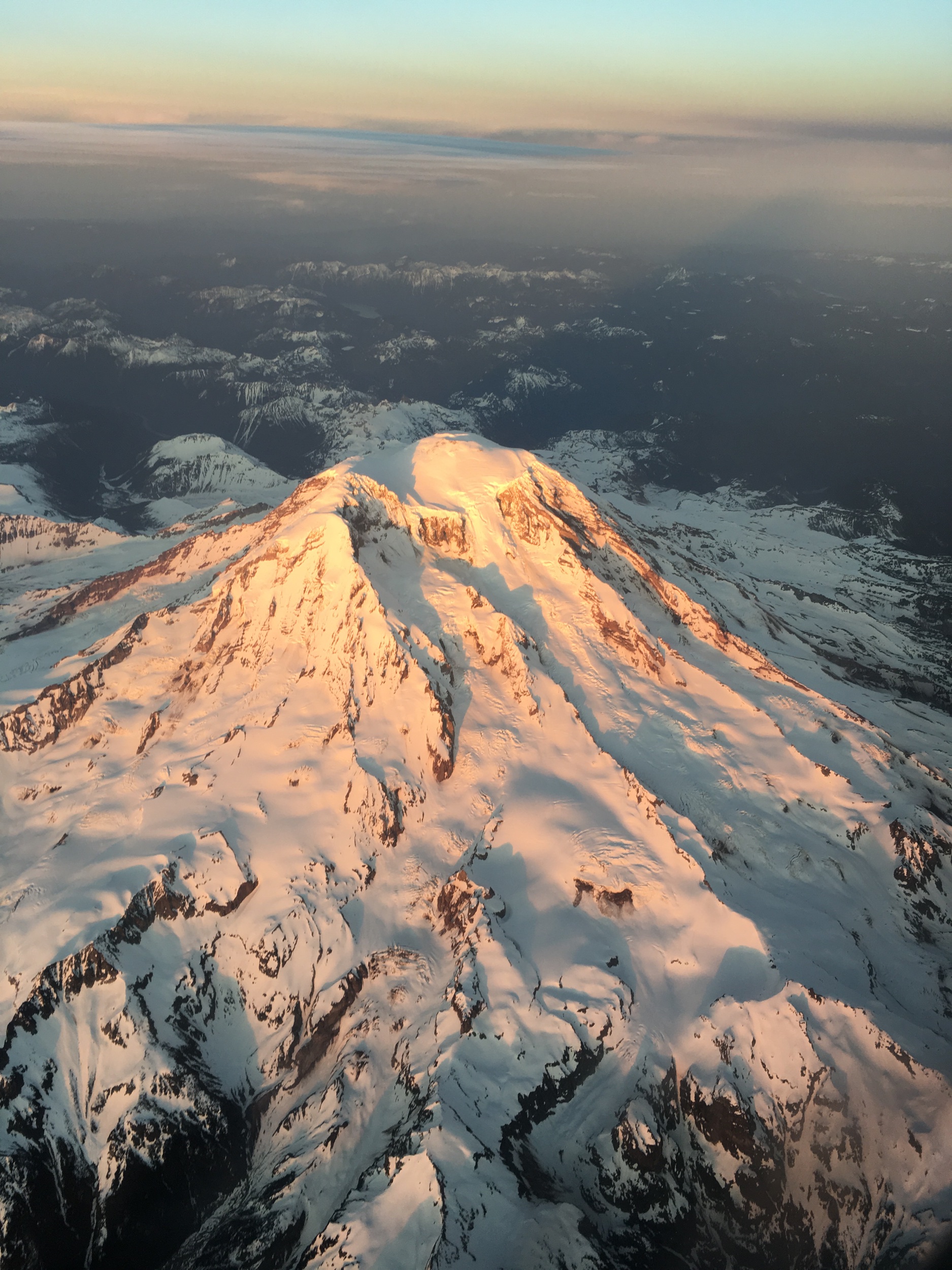 Window seat view of unknown snow capped peak